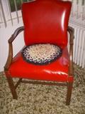 Red vinyl upholstered chair, braided chair cushion